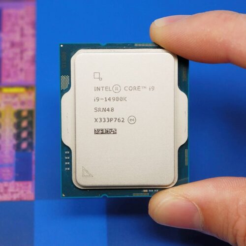 Intel Core i9 14900K CPU on a box and inside a motherboard socket.